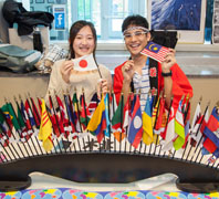International students show off flags from their countries of origin.