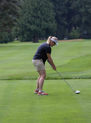 A player prepares for drive on golf links