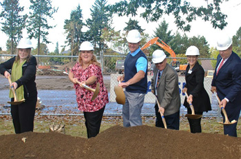 Clark student Audreyana Foster, Dena Horton, representing U.S. Sen. Maria Cantwell’s office, Vancouver Mayor Tim Leavitt, Clark County Commissioner Edward Barnes and Clark President Robert Knight, shovel the ceremonial dirt that christened the start of the college's new STEM facility.