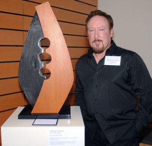 Jeffrey Grimes stands next to his piece, "Opposites Attract."
