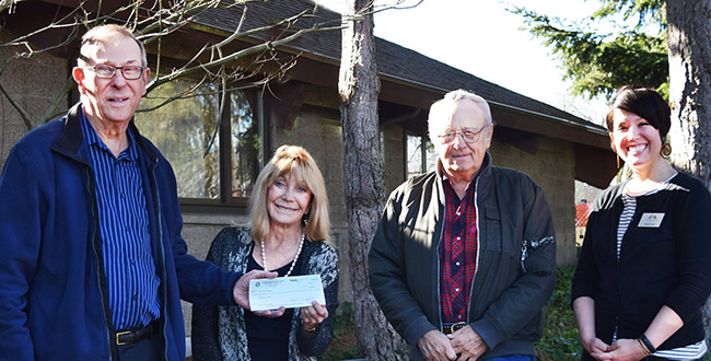American Legion's Phil Yasson hands Judy Starr, of the foundation, a $10,000 gift, while Gary Zilm from American Legion and the foundation's Kelsey Hukill look on.