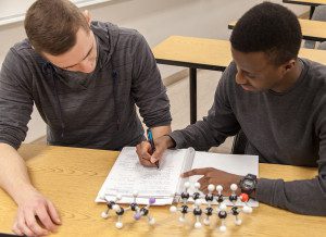 Left to right, James Kott and Takunda Masike work on a chemistry problem.