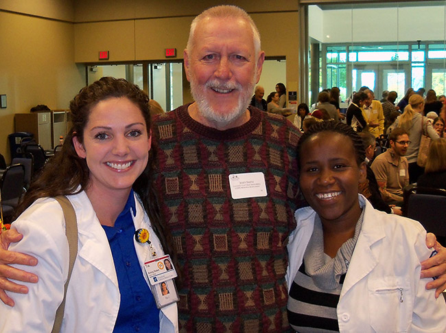 Donor Jerry Smith with Tia Clary (left) and Stellah Nyamongo (right), the Nursing students his scholarship supports. 