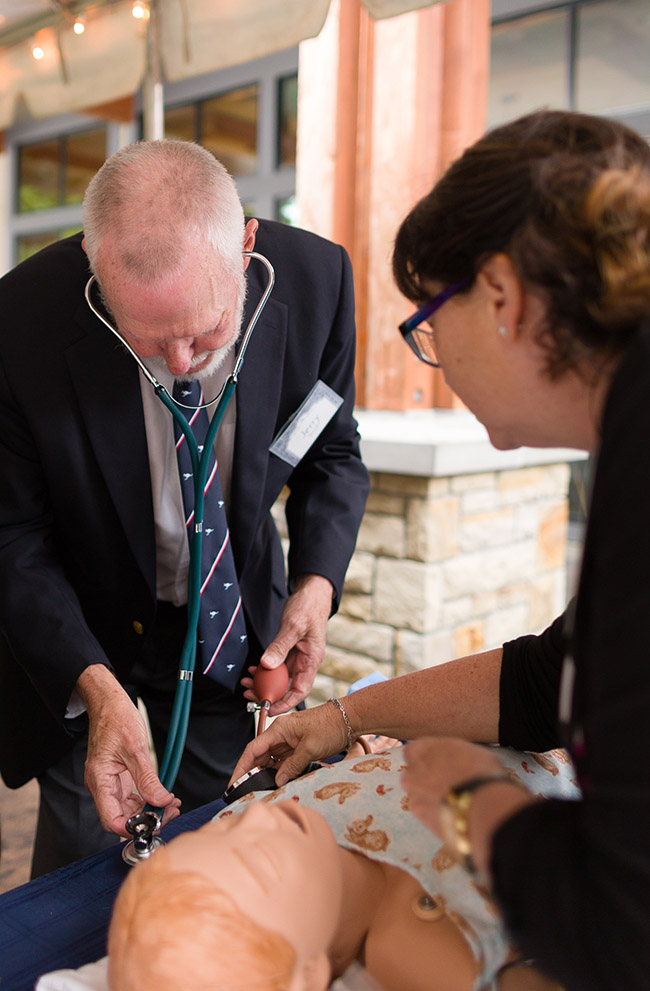Jerry Smith practicing his health care skills on a simulation model during an event in May 2016.