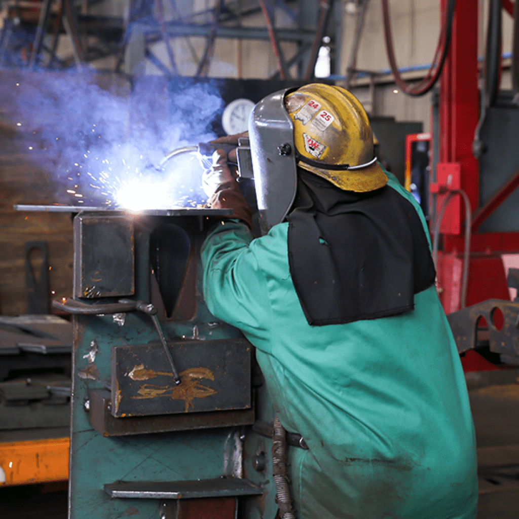Kim Clements welds a rooster tail assembly at Gunderson Marine