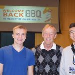 Denny Huston with two students at the 2019 Jim Raines BBQ
