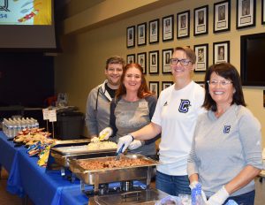 Corey Dobbs, Amanda Witt, Laura LeMasters and Marla Derrick serving food and snacks at the 2019 Jim Raines Welcome Back BBQ