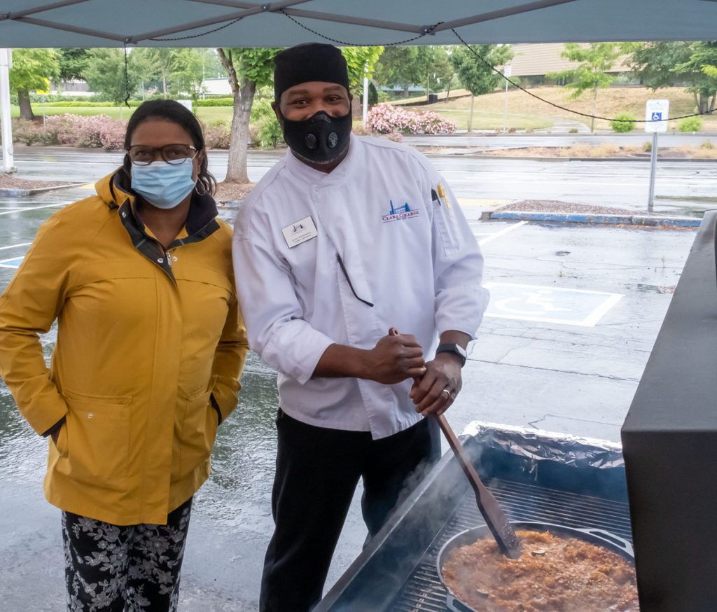 Clark College President Karin Edwards and Earl Frederick, cuisine management professor, prepareto greet students during the college’s first Juneteenth barbecue in June 2021.