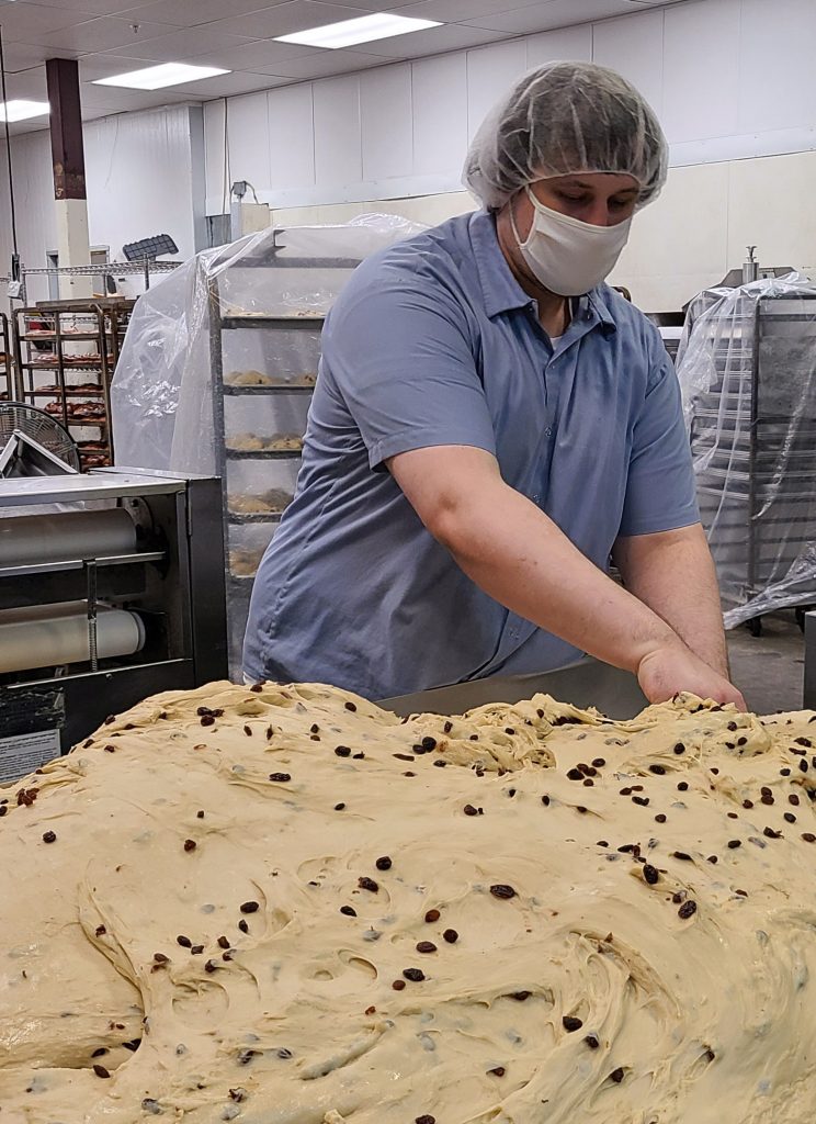 Ryan Fowler ’21 prepares dough for braided sweet raisin bread at Eurobake Bakery in Portland, Ore.