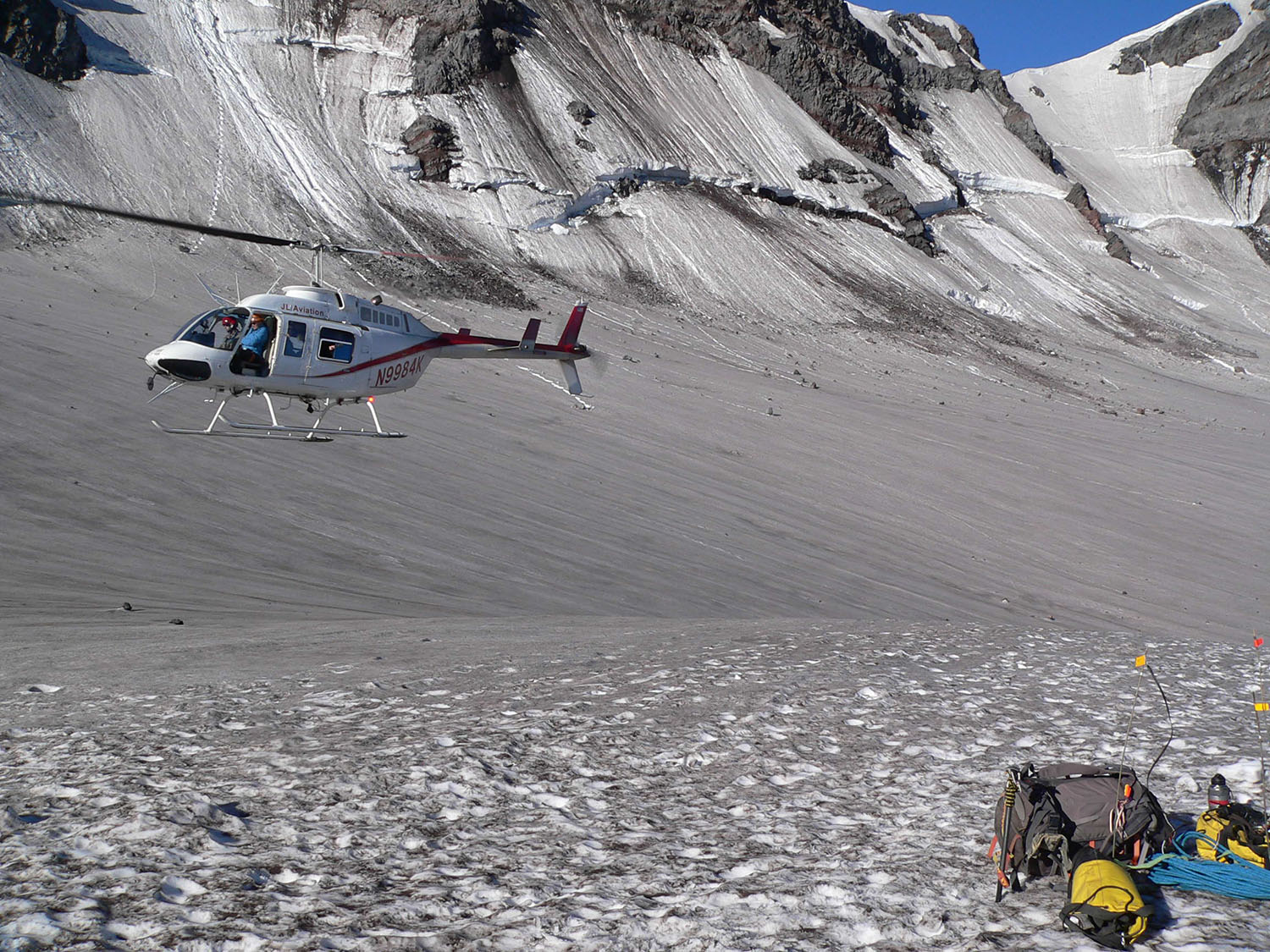 A look inside the crater on Mt. St. Helens, with a pile of research expedition equipment and the helicopter that took scientists to and from the crater.