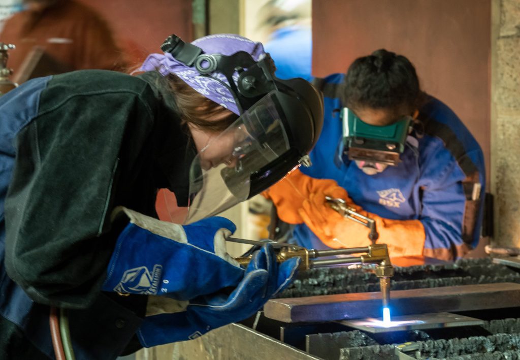 Ada Owens and Abigael Rubio-Esteban practice their welding techniques.