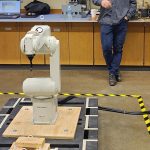 A robot with student-designed hooks on demonstration during a 2022 capstone project at Clark College.