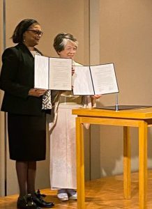 President Edwards displays a proclamation agreement with a representative from Kyoto Woman’s University in Joyo, Japan.