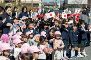 School children greet visitors in Joyo, Japan.
